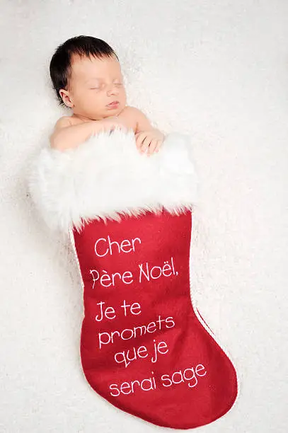 babyborn in a Christmas stocking. studio shot. Available without french text.Please this similar picture from my portfolio :