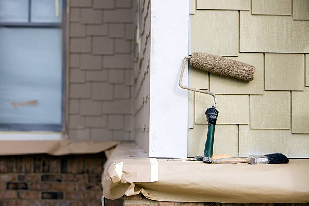 istock Paint Roller, Brush and Putty Knife rest near New Siding 183508803