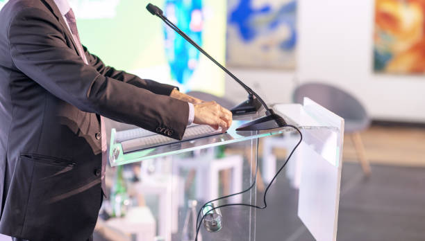 istock Speaker at business conference, corporate presentation, workshop, coaching training, news conference, company meeting, public or political event. Public speaking concept. 1835095337