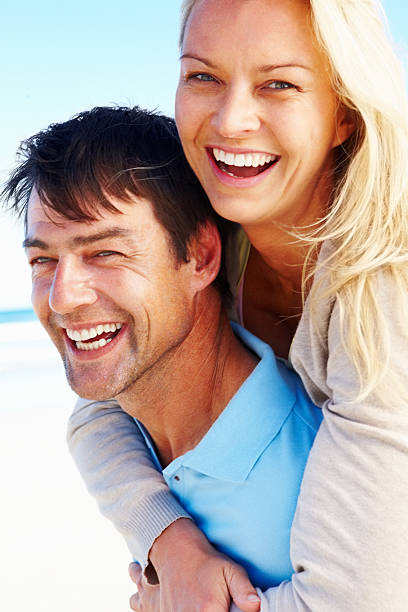 istock Couple smiling as they enjoy a piggyback ride 183510330