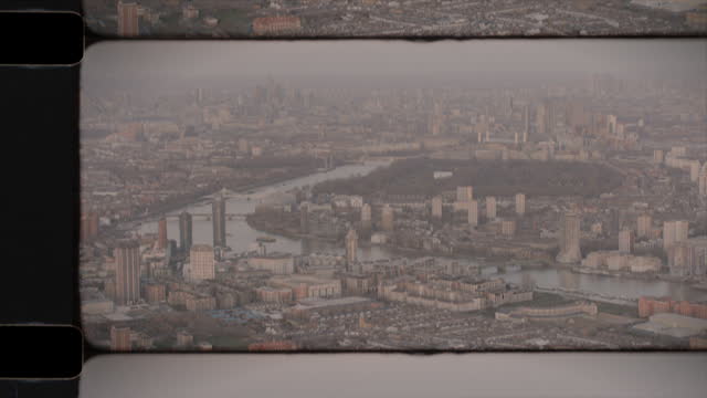 Old Film Aerial View of the River Thames in West London, UK, with Central London in the Distance. 4K