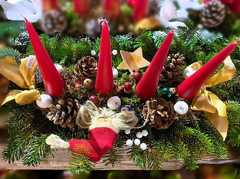 Christmas decoration with red candle, pine cones, spruce branches on white background