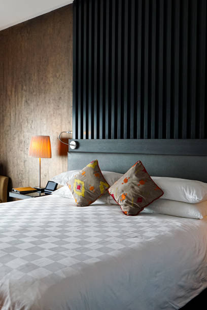 Bed with pillows, headboard in bedroom