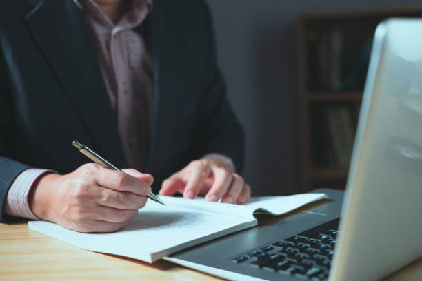 istock Man using smartphone and taking notes in planning. which is payment online, sits on the chair in the living room at home on a desktop. The concept of finance and online shopping. 1835124428