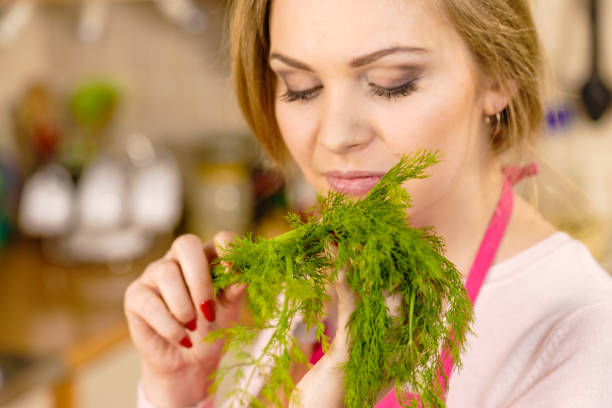 istock Woman smelling green dill herb 1835126562