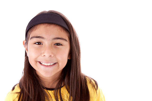 Beautiful Hispanic girl smiling and looking wide eyed into the camera.