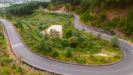 Aerial view of Ta Nung Pass in Da Lat City, Vietnam in the morning. The winding road in the distance is Dalat city, Vietnam. Long exposure.