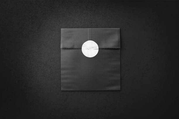 Blank black rectangle paper bag with sticker mockup, dark background