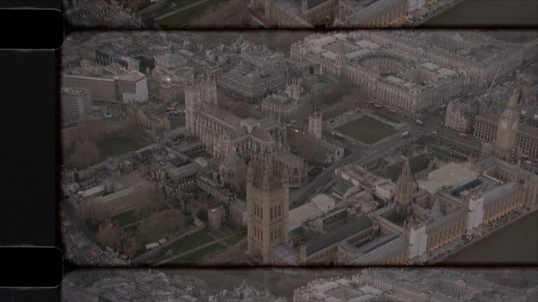 Old Film Aerial View of The Houses of Parliament in London, UK at sunset. 4K