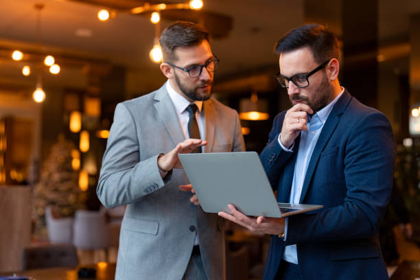 istock Two business people using a laptop in a meeting 1835149096