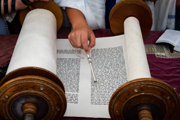 Reading from a Torah scroll using a pointer or yad stock photo