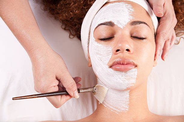 istock Woman getting white mud painted on her face 183515358