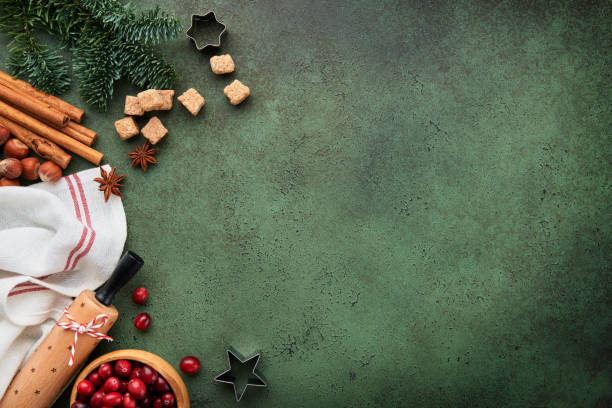 istock Christmas culinary background with ingredients for cooking christmas baking cranberries, sugar, cinnamon and Christmas tree branches on old green concrete rustic background. Top view copy space. 1835154455