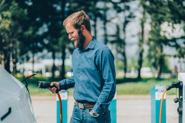 istock Man charging electric car 1835155093