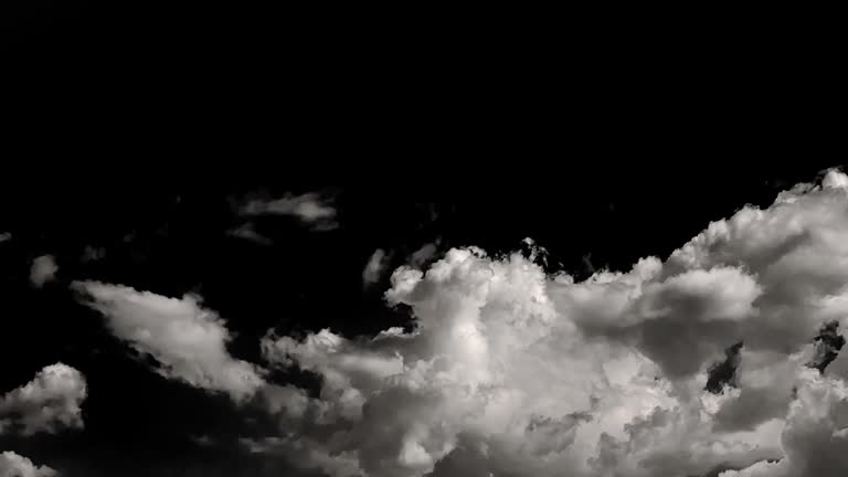 time-lapse of separate white clouds on a black background have real clouds.