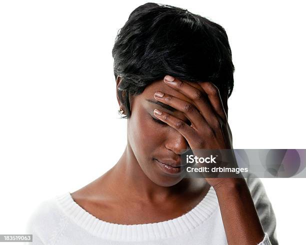 Sad Young Woman Looks Down And Covers Eyes Stock Photo - Download Image Now - Women, White Background, Head In Hands