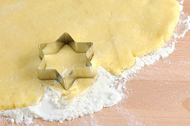 istock wood rolling pin and star shape pasty cutter on dough 183519855