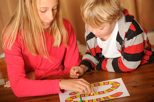 istock Brother and sister are playing a board game 183520079
