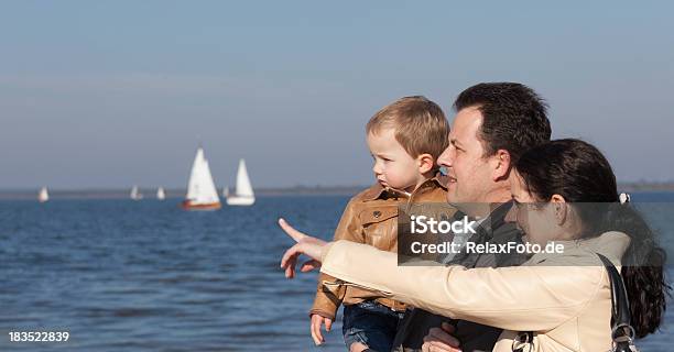 Young Family Standing At Lake Stock Photo - Download Image Now - Family, Pointing, Happiness