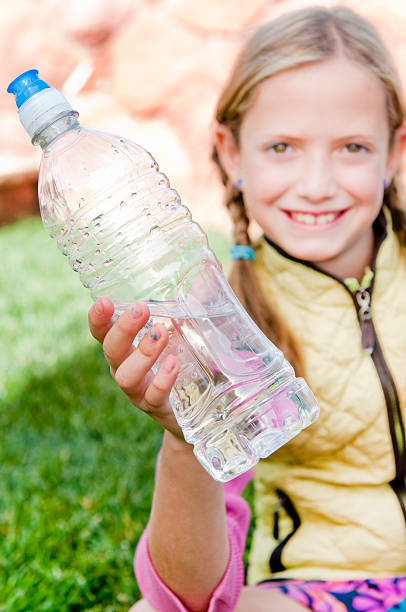 istock Little Girl holding a plastic water bottle 183523342