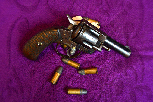 Pistol 9mm on wooden background. Black metal gun weapon, automatic handgun for military and security on a vintage table. Side view