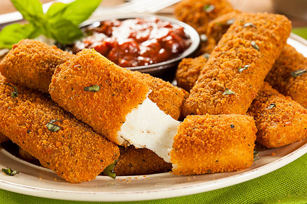 Homemade Fried Mozzarella Sticks Homemade Fried Mozzarella Sticks with Marinara Sauce stick plant part stock pictures, royalty-free photos & images