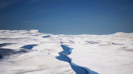 The Arctic desert, draped in the calm embrace of frozen, snow-covered vistas, reveals a pure and tranquil winter tableau.