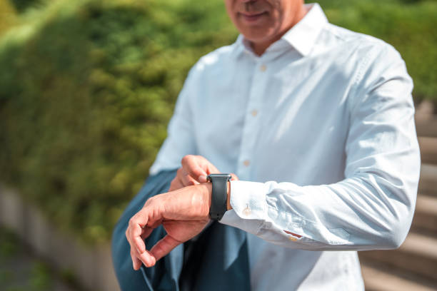 istock Business Executive in Stylish Attire Using Smart Watch 1835247119