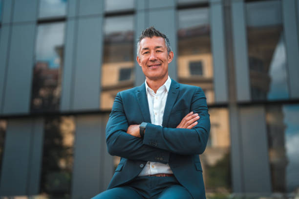 istock Asian Executive in Suit with Arms Crossed Outside Office 1835247141