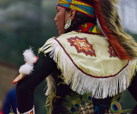 This Powwow was celebrated in White Rock, British Columbia, Canada on 10 March 2018. The Squamish Nation's annual powwow is a gathering of First Nations communities to honour their culture, share, respect, dance and drum. Their heritage is respected by all ages. The grass dancer, is watching, waiting to dance.