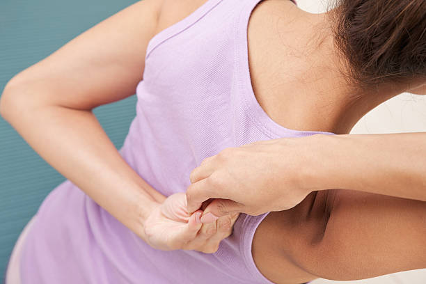 istock Attractive woman on mat stretching back and shoulders 183525295