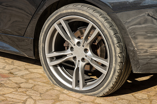 Close-up shot of a car with a flat tire