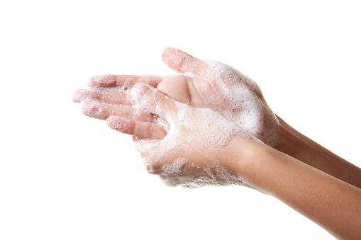 A woman washing her hands with a soap suds