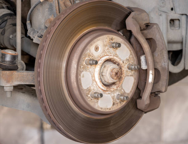 istock Disk brake pad and car disk brake system change service. Car disk brake pad replacement service by hand of mechanic man in car garage. Process of replacing brake pads with new 1835259694