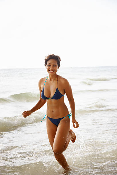 istock Young bikini woman enjoying vacation on beach 183526084