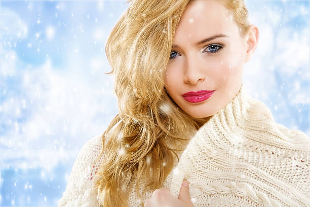 Portrait of young blonde woman in winter forest.