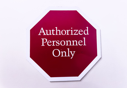 Authorized personnel sign against industrial backdrop, emphasizing restricted access and safety protocols