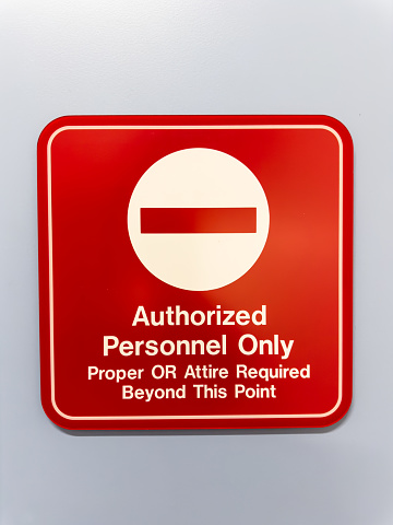 Authorized personnel sign against industrial backdrop, emphasizing restricted access and safety protocols