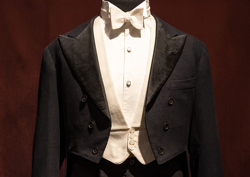 Old model classic men's tuxedo man dress. on mannequin Black jacket, white shirt, white bow tie
