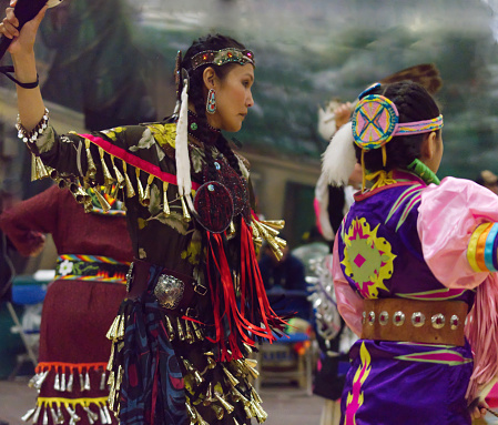 This Powwow was celebrated in White Rock, British Columbia, Canada on 11 March 2018. The Squamish Nation's annual powwow is a gathering of First Nations communities to honour their culture, share, respect, dance and drum. Their heritage is respected by all ages. This image displays a jingle dancer in the foreground.