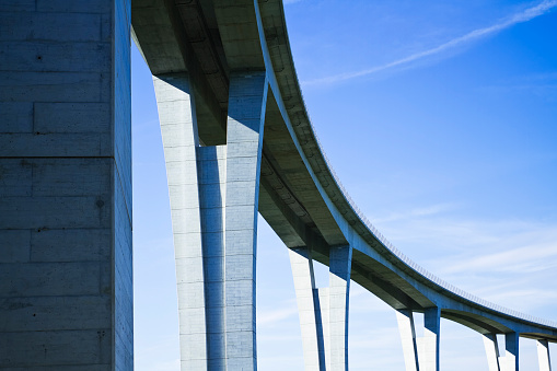 Close up of highway viaduct in front of a clear blue sky