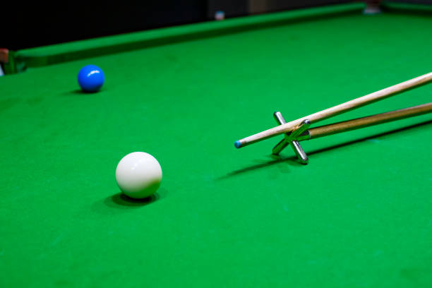 istock Snooker table. Aiming the cue ball with spider stick. 1835292692