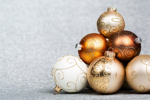 Christmas Baubles on silver glitter background