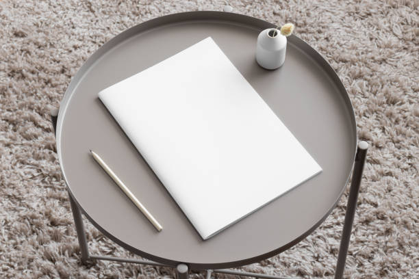 istock Magazine mockup with a lagurus and a pen on the beige table. 1835293892