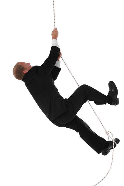 uomo d'affari arrampicata corda - climbing clambering hanging rope foto e immagini stock