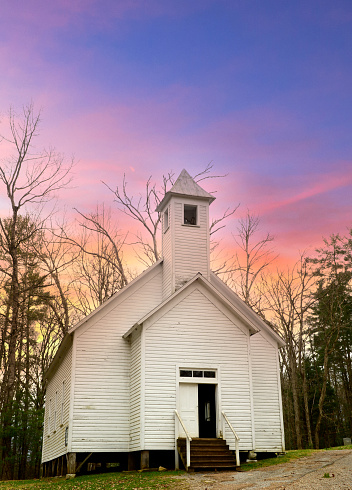 Old weathered church in the mountains of Kentucky with a dramatic sunset sky