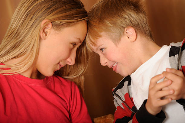 istock Sister and brother with down syndrome looking at each other. 183532035