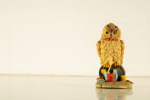 Close-up of clay decoration owl statuette Object on a White Background