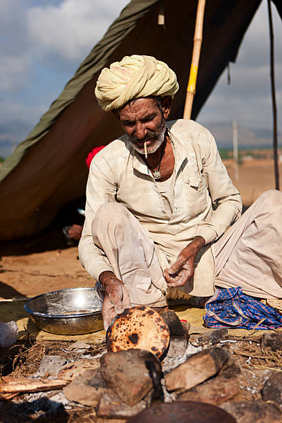 istock Indian men preparing chapatti bread during festival in Pushkar 183533727
