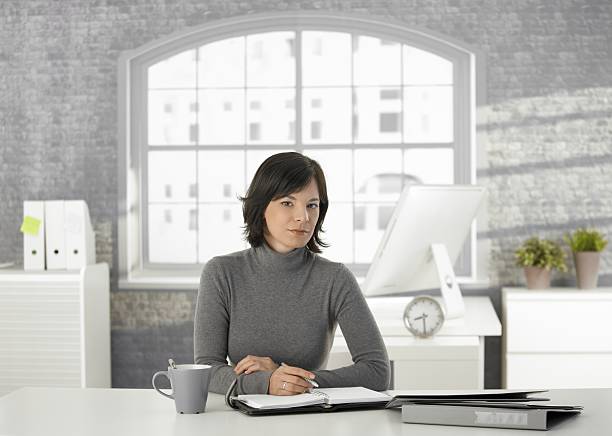 istock Young woman writing into personal organizer at home 183533758